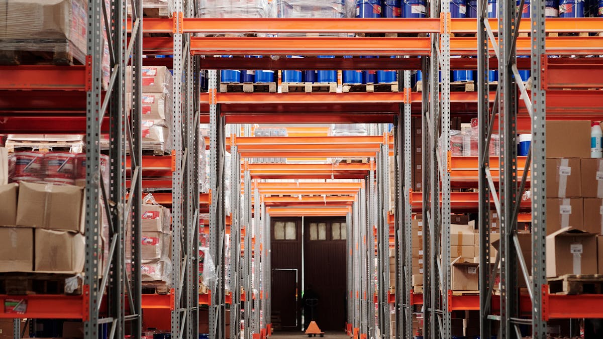 Warehouse worker scanning stock on shelves with a barcode reader